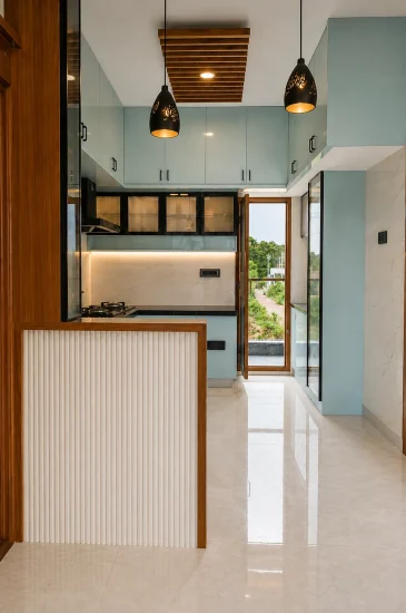 View of the Laxman project kitchen in Rahuthnalli, Bangalore, with white cabinets, a dark countertop, and wood-finish details.