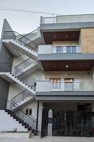 Front exterior of the completed Palaksha Residency turnkey residential project in Bagalgunte, Bangalore, showing its balconies and external staircase