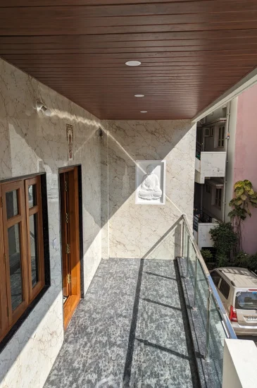 Balcony corridor at the completed Palaksha Residency in Bagalgunte, Bangalore, with a wood-finish ceiling, tiled floor and railing